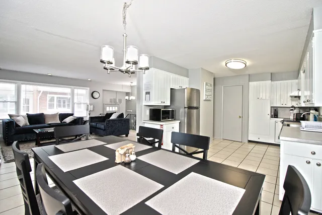 a living room with lots of furniture and chandelier