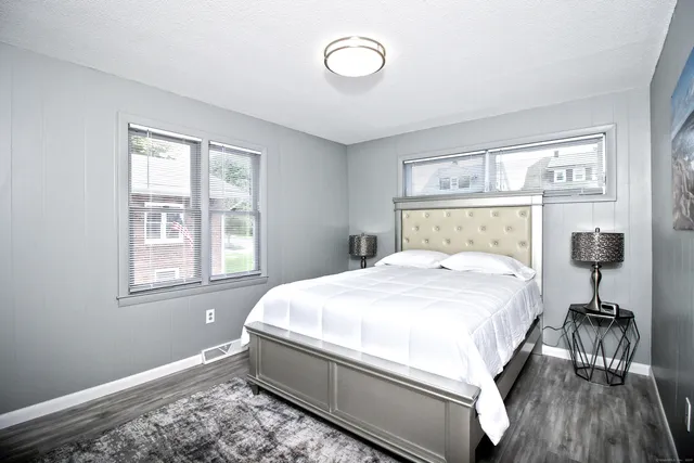 a bedroom with a bed and a lamp