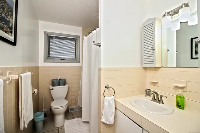 a spacious bedroom with a bed and a flat screen tv