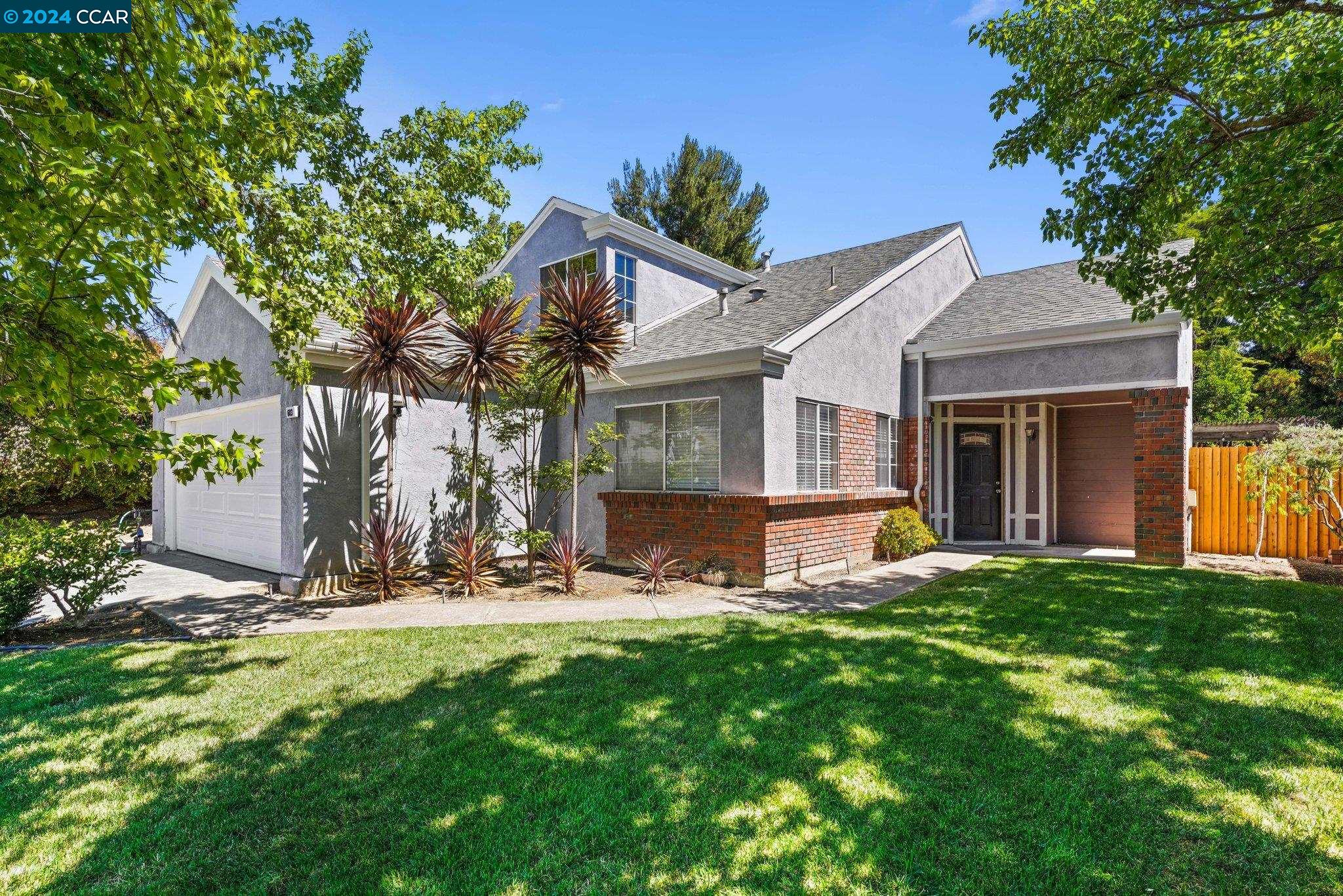a view of a house with a yard and plants