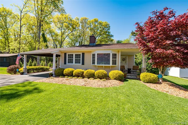 a view of a house with a yard patio and a garden