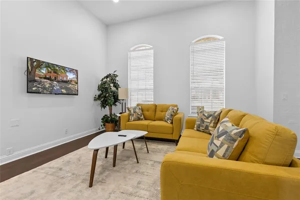 a living room with furniture and a potted plant
