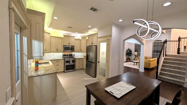 a kitchen with refrigerator and microwave