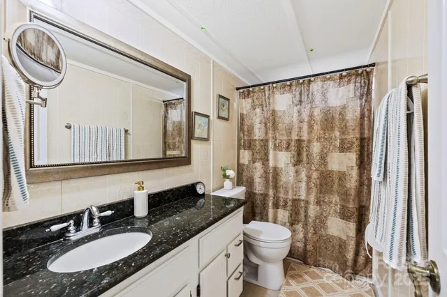 a kitchen with stainless steel appliances kitchen island granite countertop a refrigerator and microwave