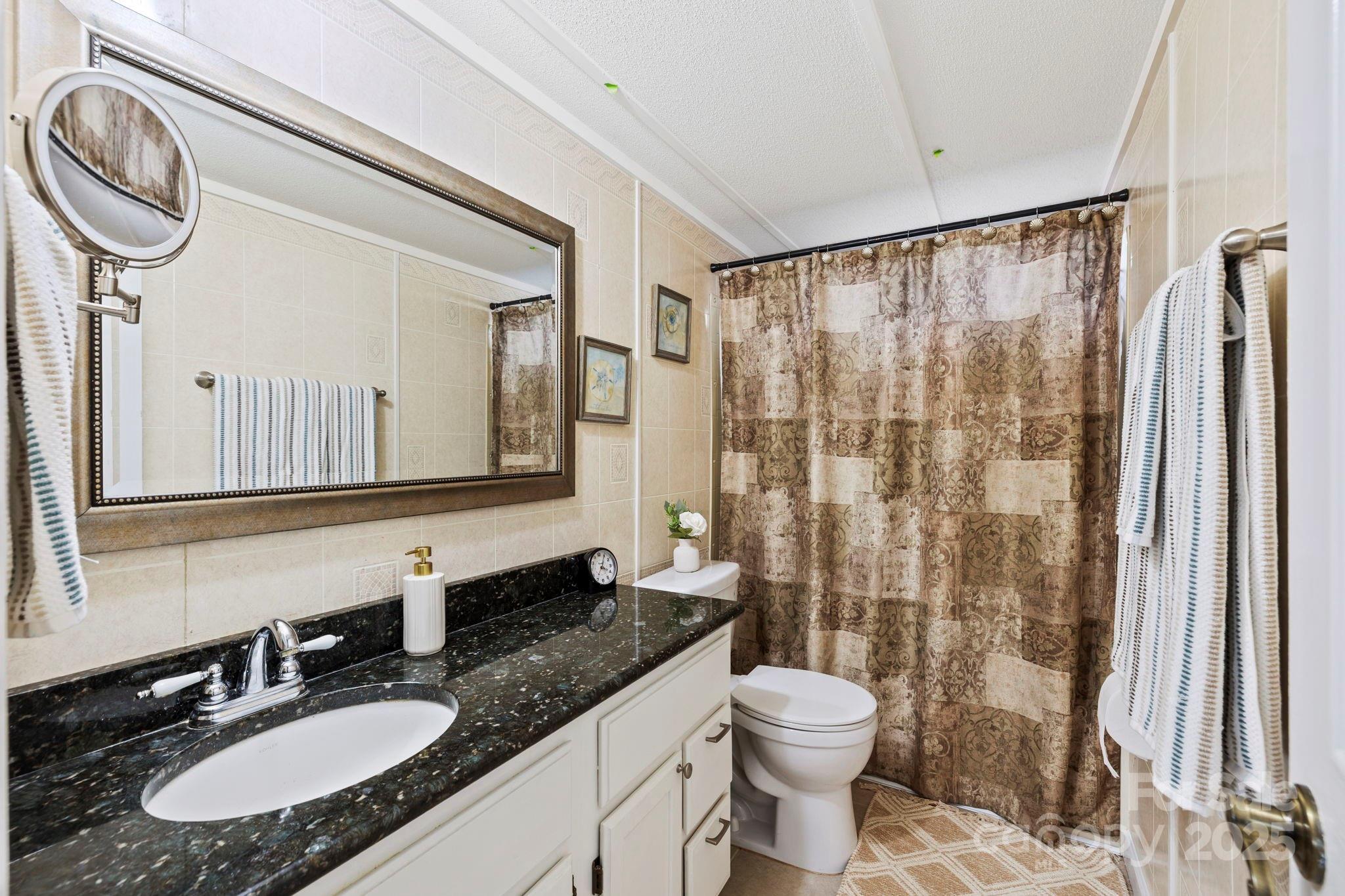 12 Timbers Edge Lane Fairview, NC 28730 - Photo 13 of 35 a bathroom with a granite countertop sink toilet and shower