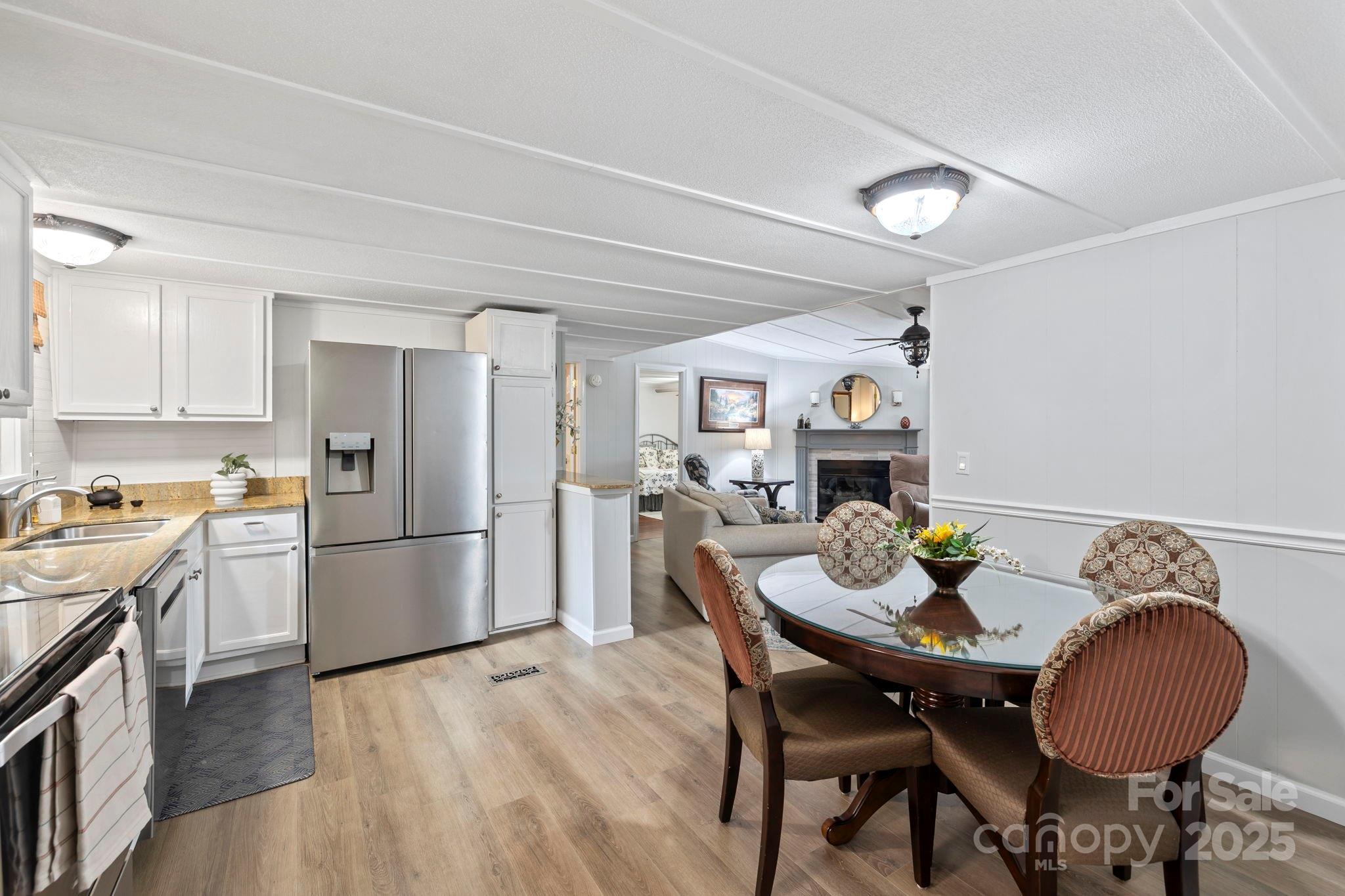12 Timbers Edge Lane Fairview, NC 28730 - Photo 15 of 35 a kitchen with granite countertop stainless steel appliances a dining table and chairs