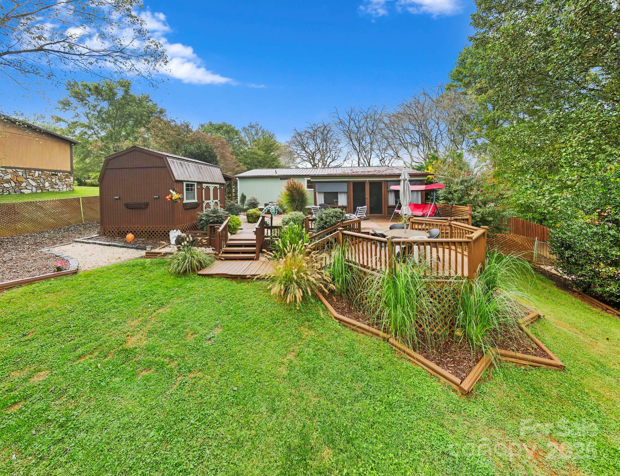 12 Timbers Edge Lane Fairview, NC 28730 - Photo 23 of 35 a view of a house with backyard and a patio