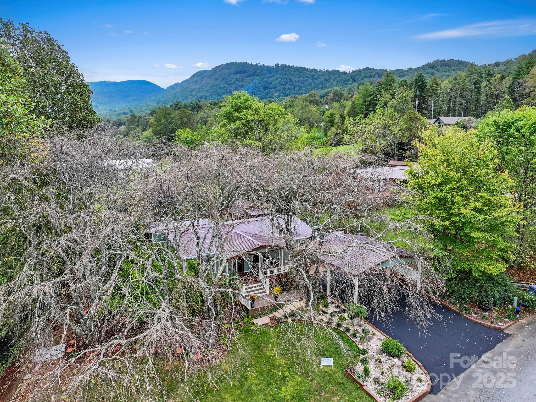 12 Timbers Edge Lane Fairview, NC 28730 - Photo 26 of 35 a view of a lush green hillside and a building