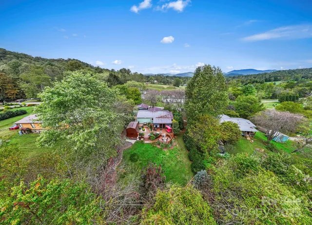 a view of a house with garden and sitting area