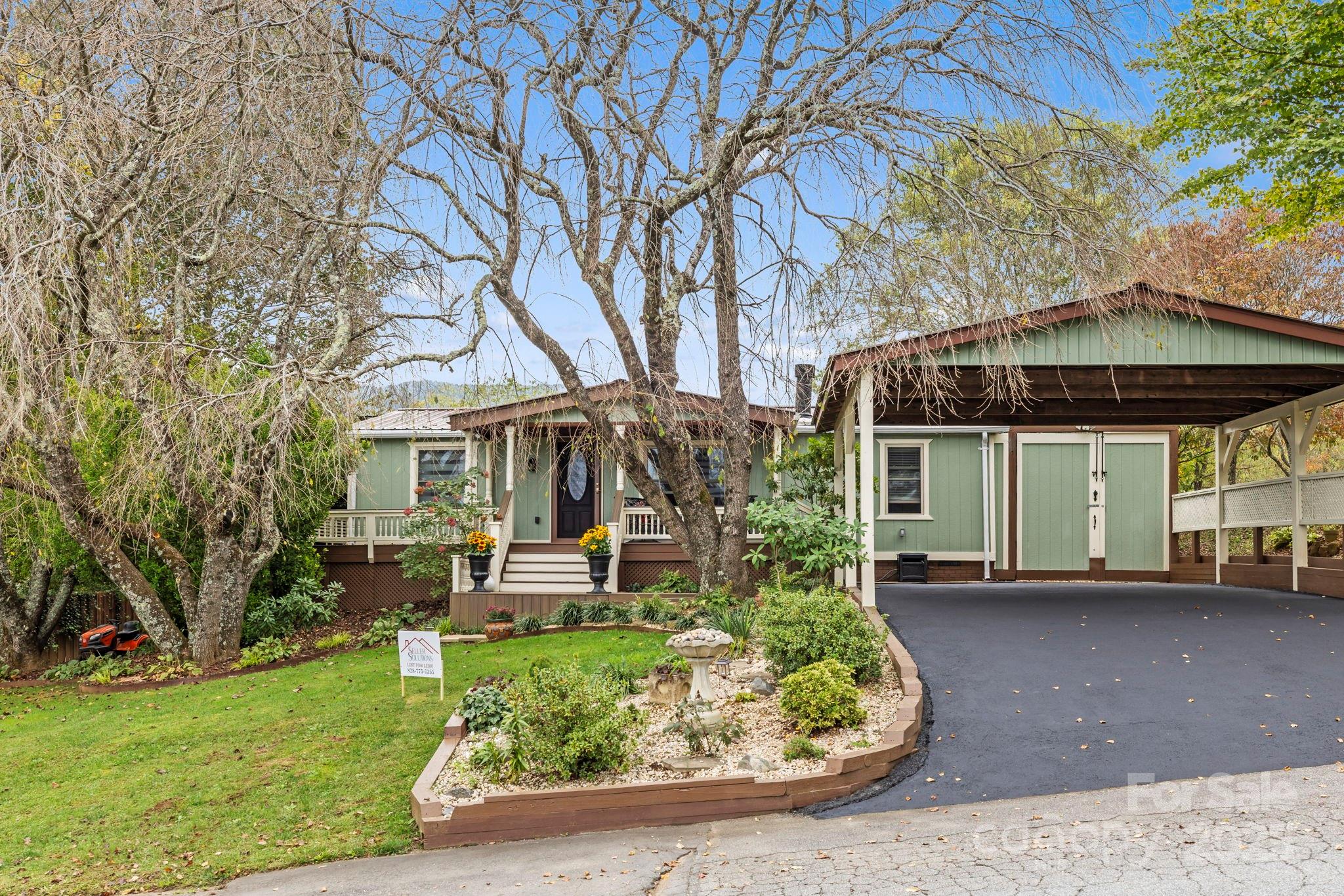 12 Timbers Edge Lane Fairview, NC 28730 - Photo 32 of 35 a view of a house with garden and sitting area