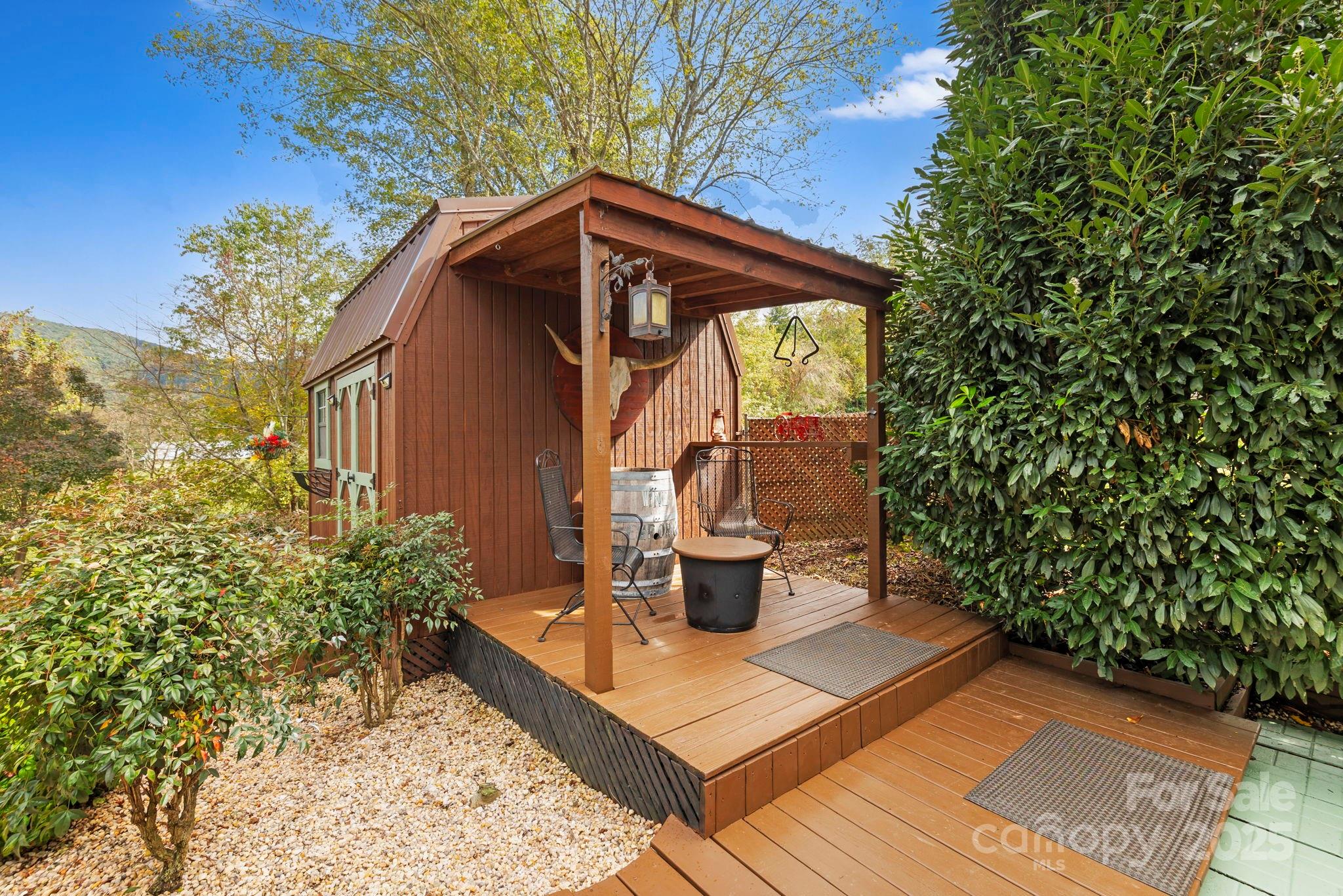 12 Timbers Edge Lane Fairview, NC 28730 - Photo 5 of 35 a view of a small house with roof and potted plants