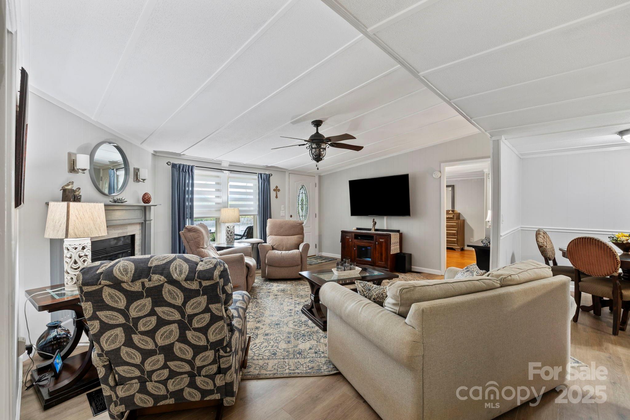 12 Timbers Edge Lane Fairview, NC 28730 - Photo 8 of 35 a living room with furniture a flat screen tv and a fireplace