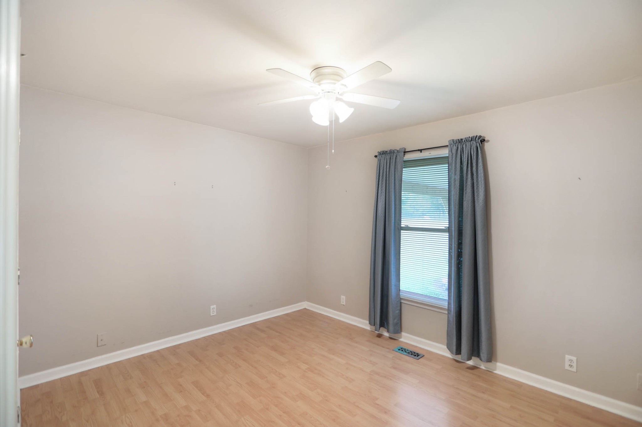 4971 Hyde Road Springfield, TN 37172 - Photo 18 of 36 an empty room with a chandelier fan and windows