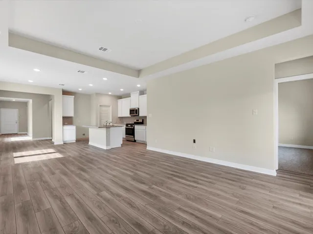 a view of kitchen with kitchen island wooden floor and center island