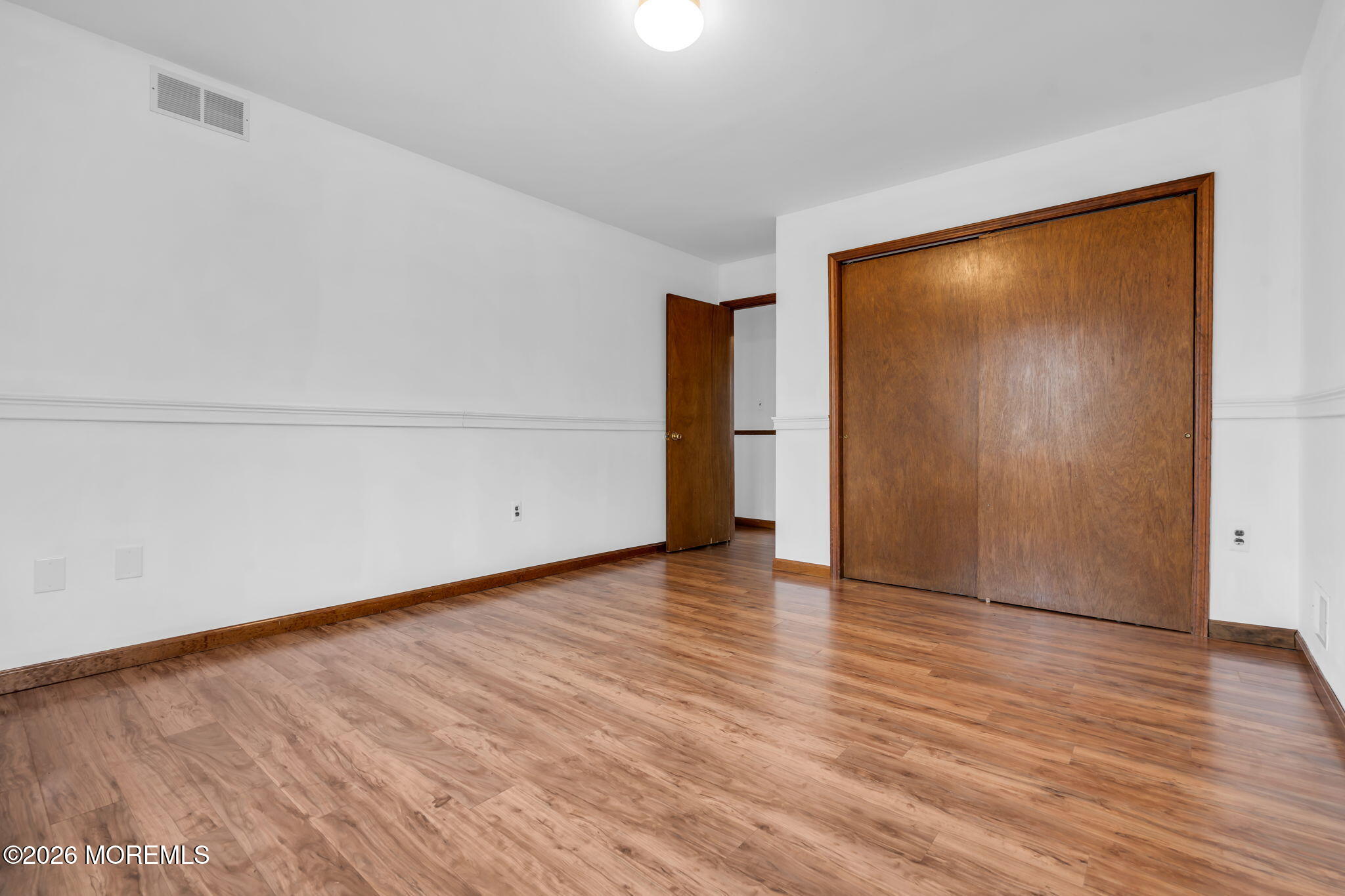 106 Vienna Road Howell, NJ 07731 - Photo 33 of 59 a view of an empty room with wooden floor and closet