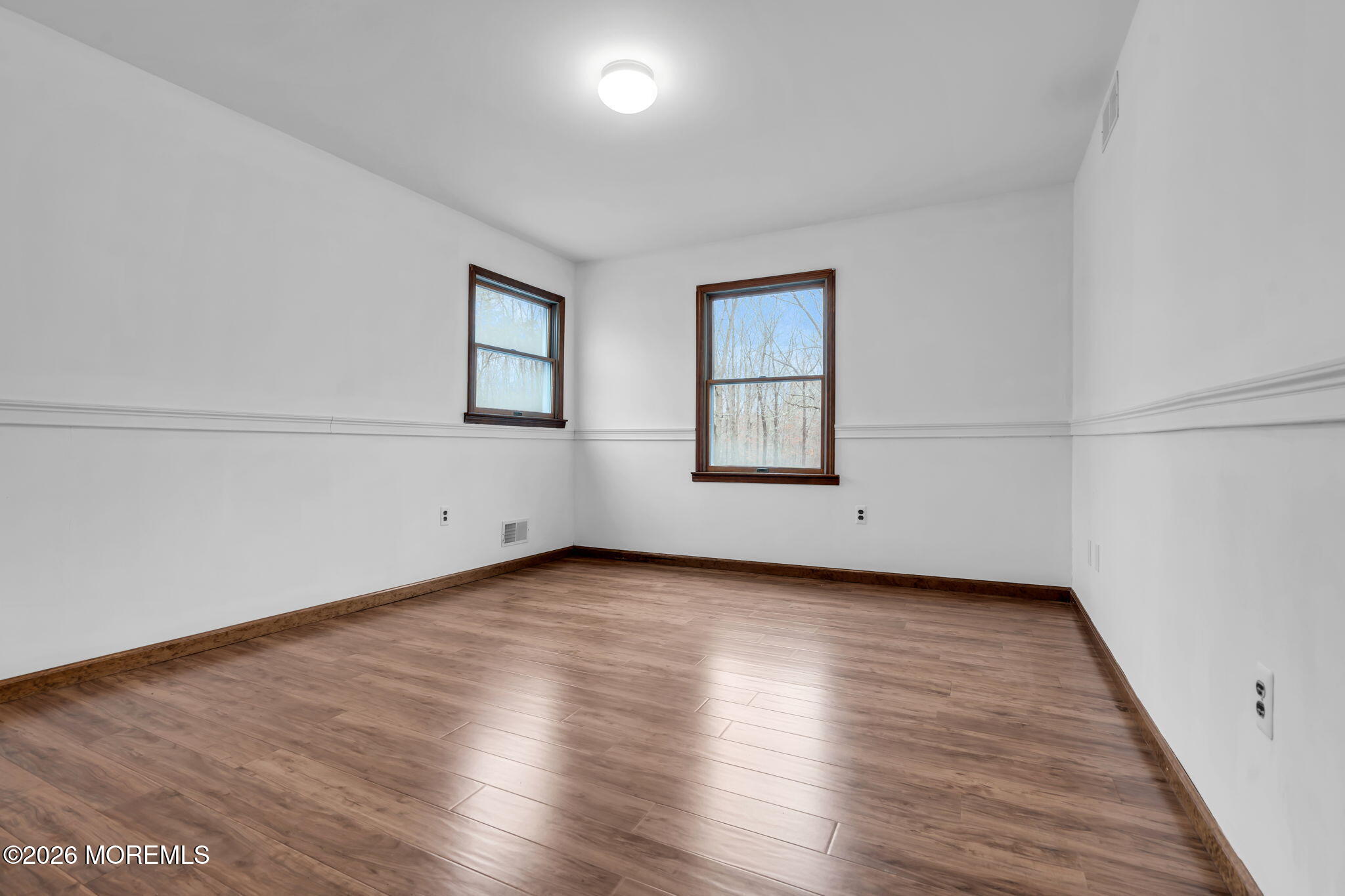 106 Vienna Road Howell, NJ 07731 - Photo 34 of 59 an empty room with wooden floor and windows