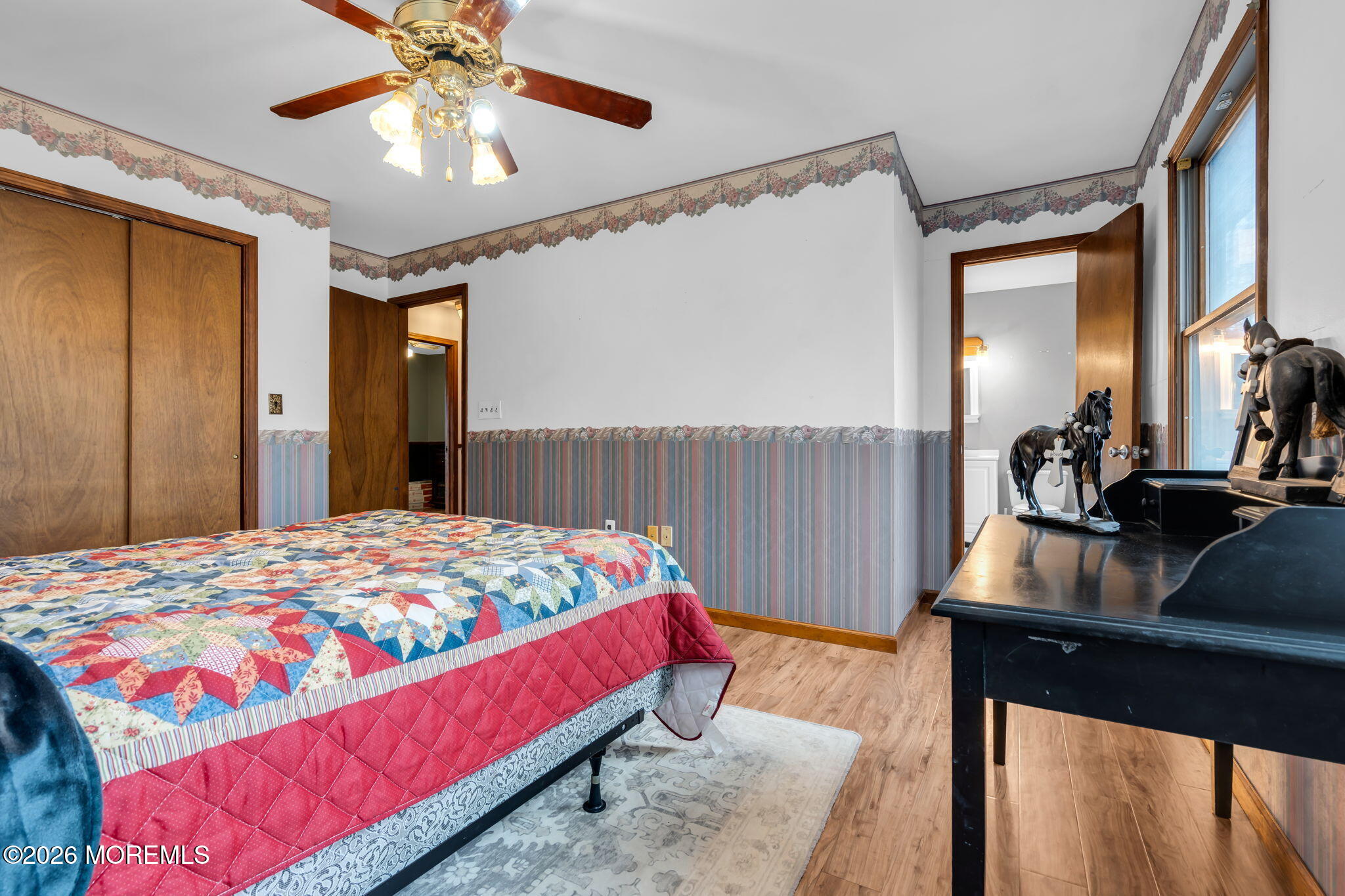 106 Vienna Road Howell, NJ 07731 - Photo 37 of 59 a bedroom with a bed and a chandelier