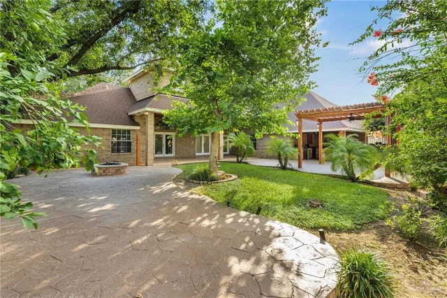 a view of a backyard with a large tree