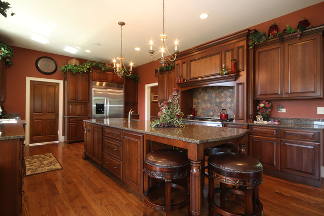 34W707 Country Club Road Wayne, IL 60174 - Photo 8 of 25 a kitchen with granite countertop a stove a sink and a refrigerator