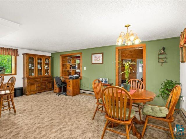 3616 Lavaque Road Hermantown, MN 55811 - Photo 43 of 43 Carpeted living space featuring an integrated wood-finish desk area with built-in shelving, a wood-frame window, and a built-in wood-finish display cabinet