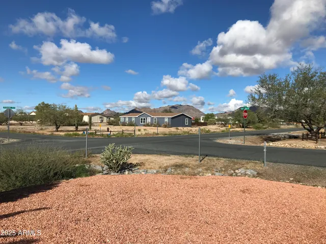 a view of a room with wooden floor and large windows