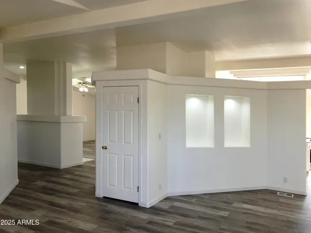 a view of a livingroom with a fireplace a chandelier and wooden floor