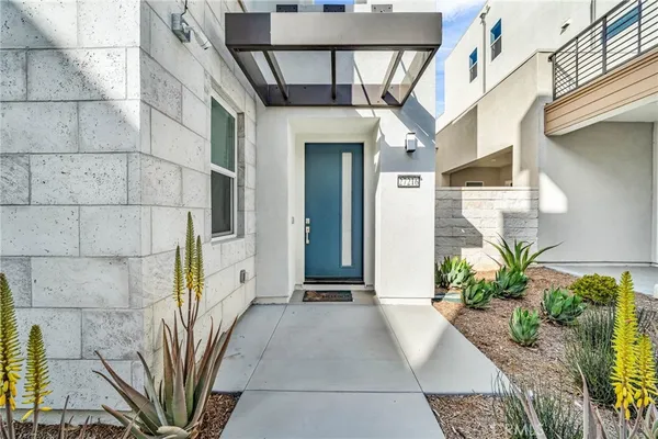 a view of a house with a potted plant