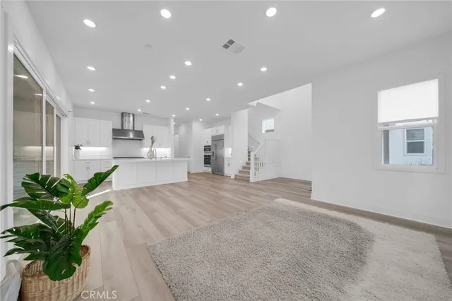a view of kitchen with stainless steel appliances kitchen island sink and refrigerator