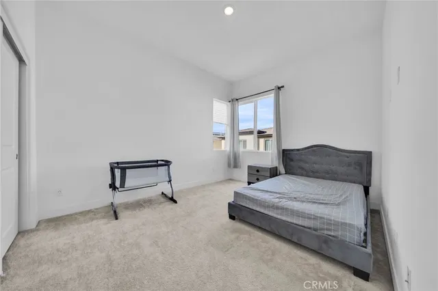 a spacious bedroom with a bed and a table in it