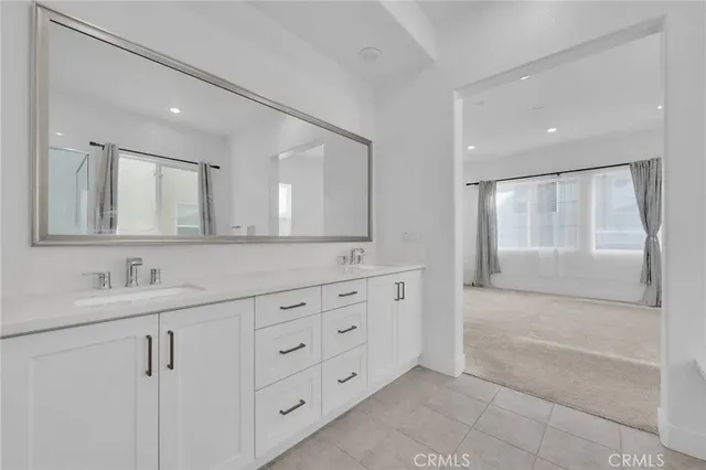 a bathroom with a double vanity sink mirror and