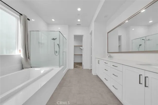 a spacious bathroom with a double vanity sink tub and shower