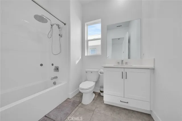 a bathroom with a shower a toilet and sink
