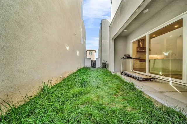 a view of a backyard with a garden and entertaining space