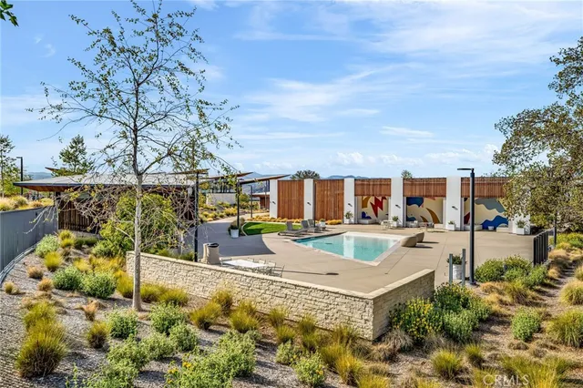 a view of a house with swimming pool and sitting area