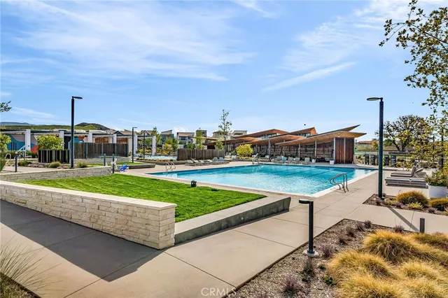 a swimming pool with outdoor seating and a patio