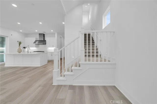 a view of entryway and hall with wooden floor