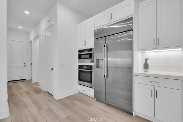 a kitchen with a refrigerator and a refrigerator