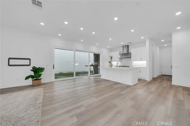 a view of kitchen with stainless steel appliances refrigerator and microwave