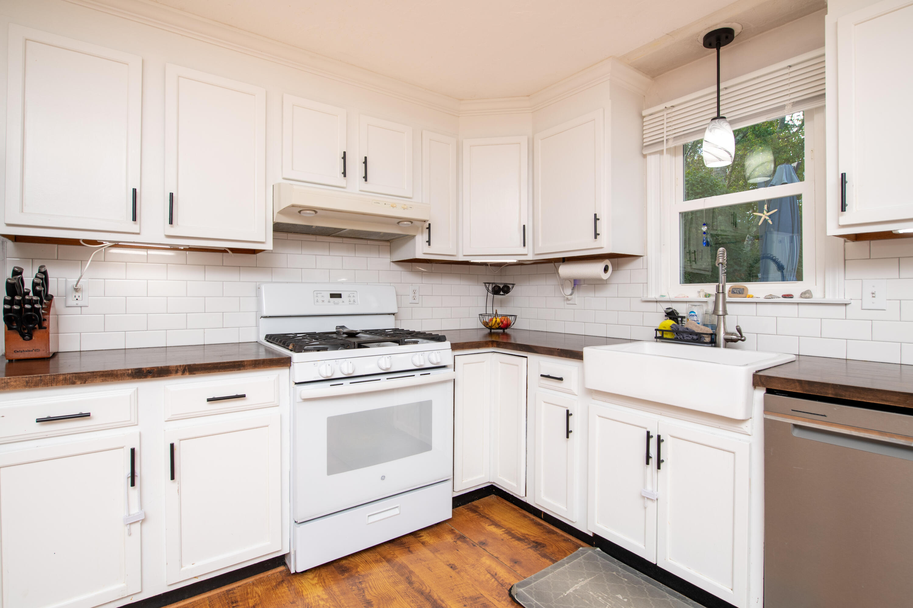 11 Warwick Way Mashpee, MA 02649 - Photo 14 of 67 a kitchen with white cabinets and white appliances