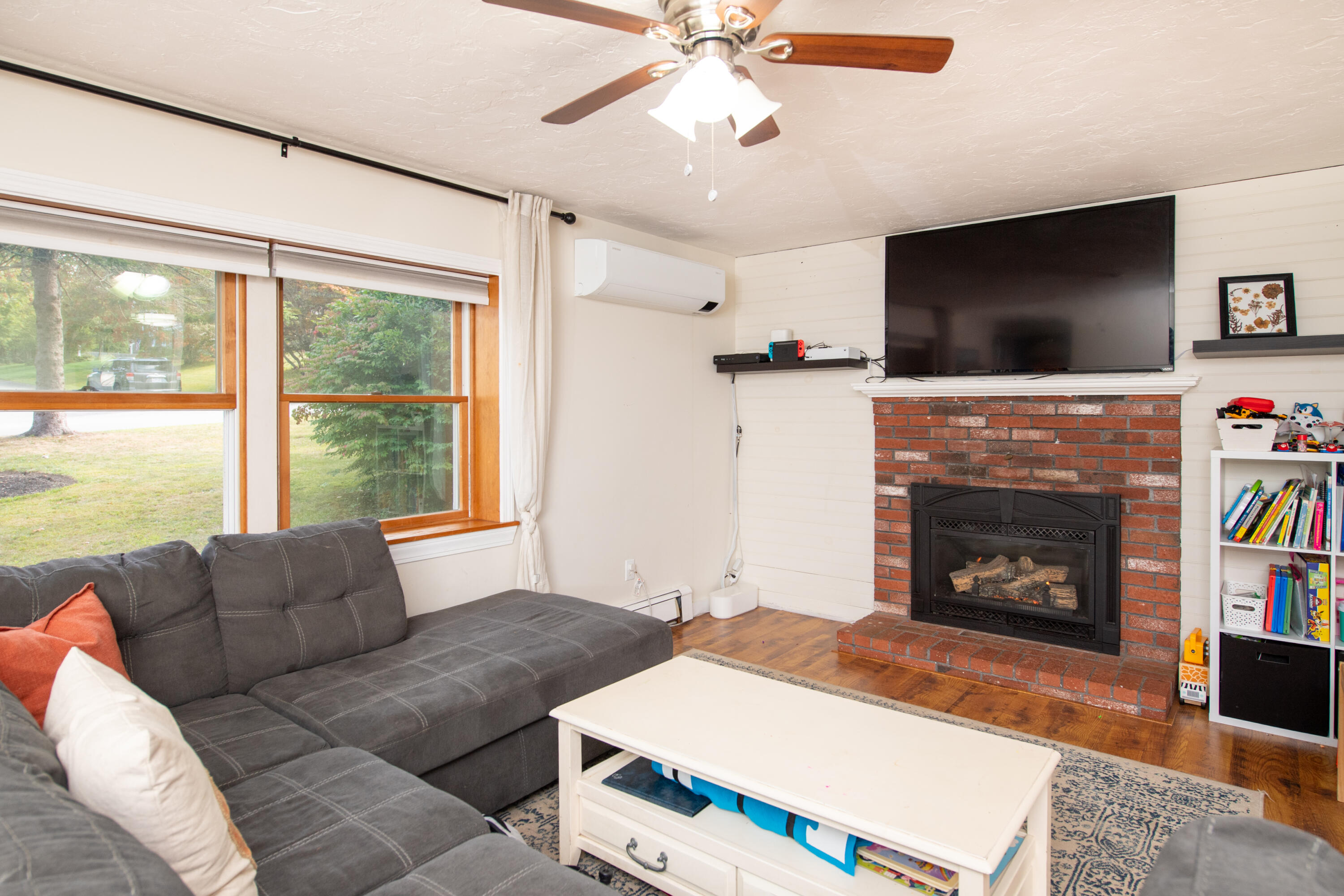 11 Warwick Way Mashpee, MA 02649 - Photo 5 of 67 a living room with furniture a flat screen tv and a fireplace