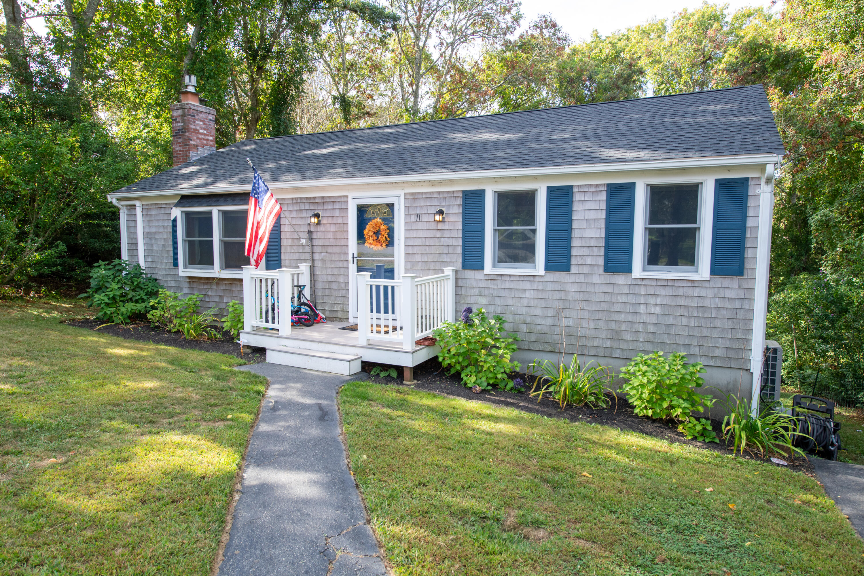 11 Warwick Way Mashpee, MA 02649 - Photo 54 of 67 a front view of a house with garden and porch
