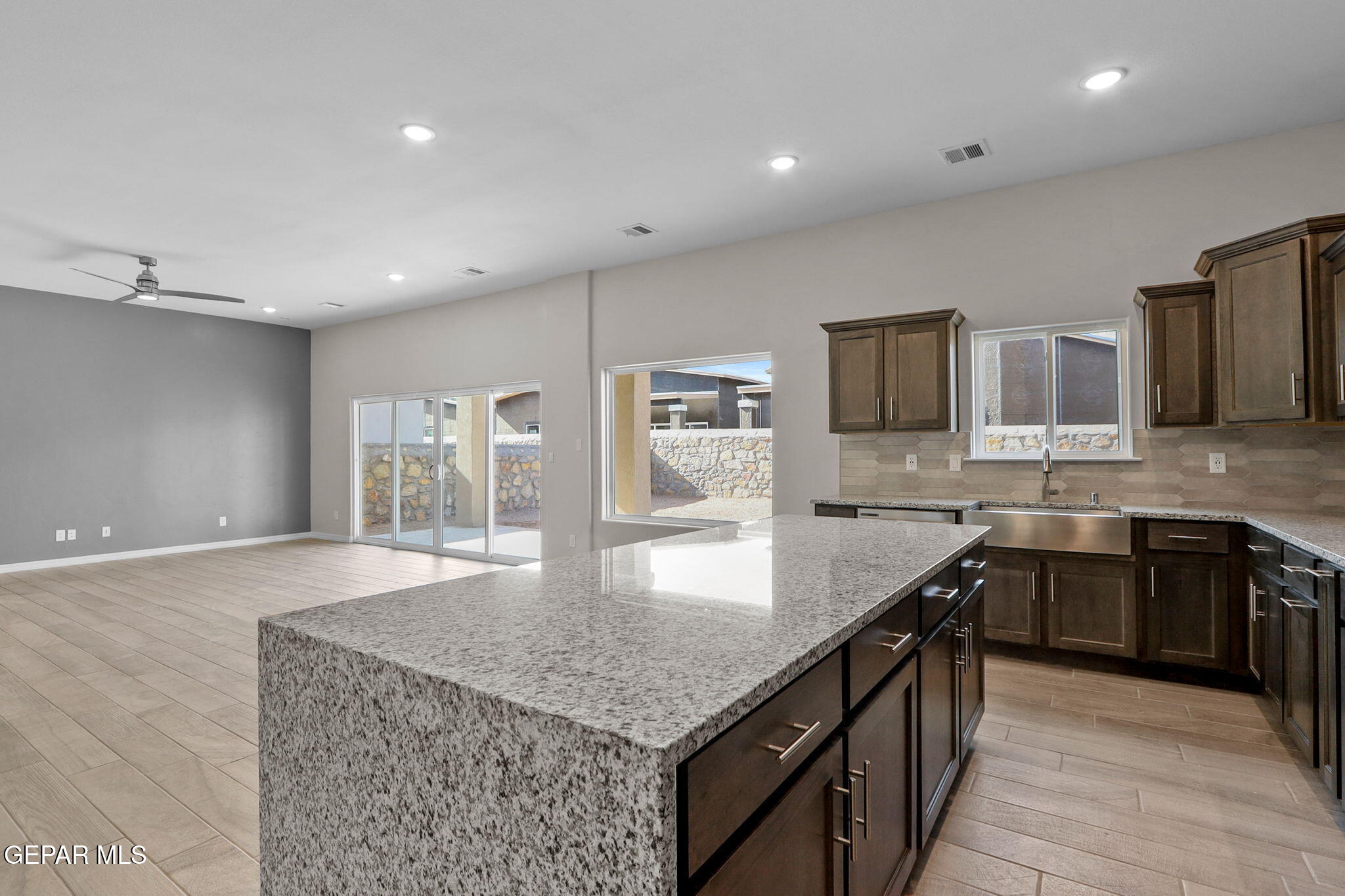 15213 Conviction Avenue El Paso, TX 79938 - Photo 23 of 41 a large kitchen with stainless steel appliances granite countertop a large counter top and a stove