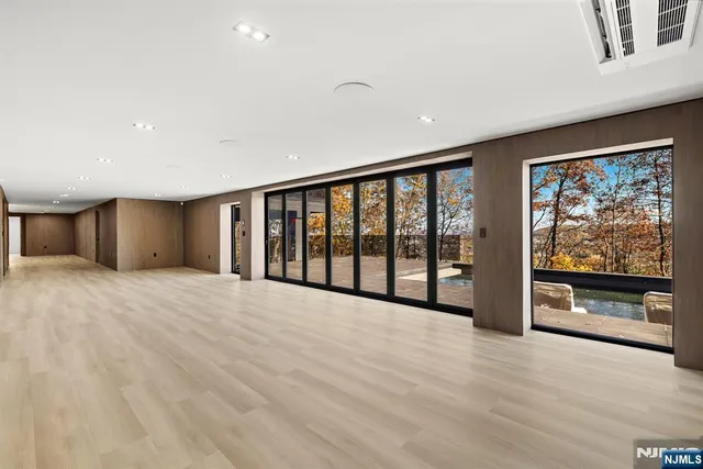 a view of hallway with wooden floor and door