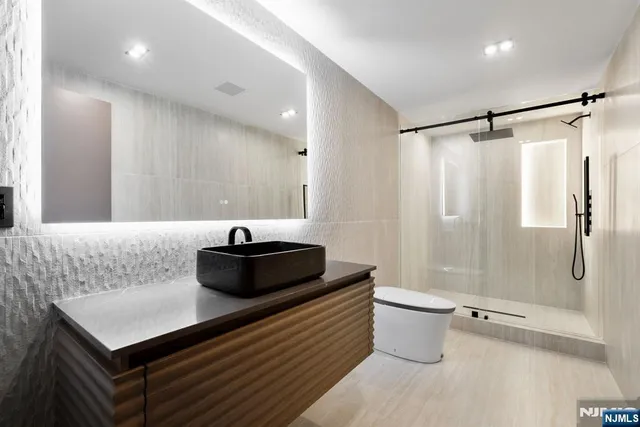 a bathroom with a sink a toilet and a shower