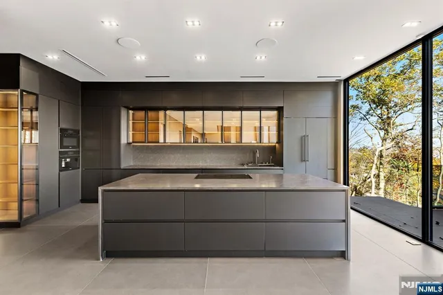 a living room with a large window and furniture