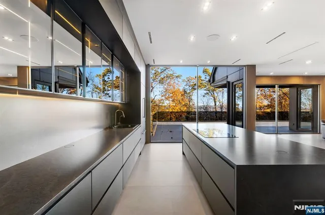 a large white kitchen with large windows