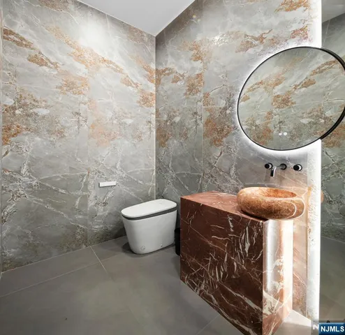 a bathroom with a toilet and a mirror