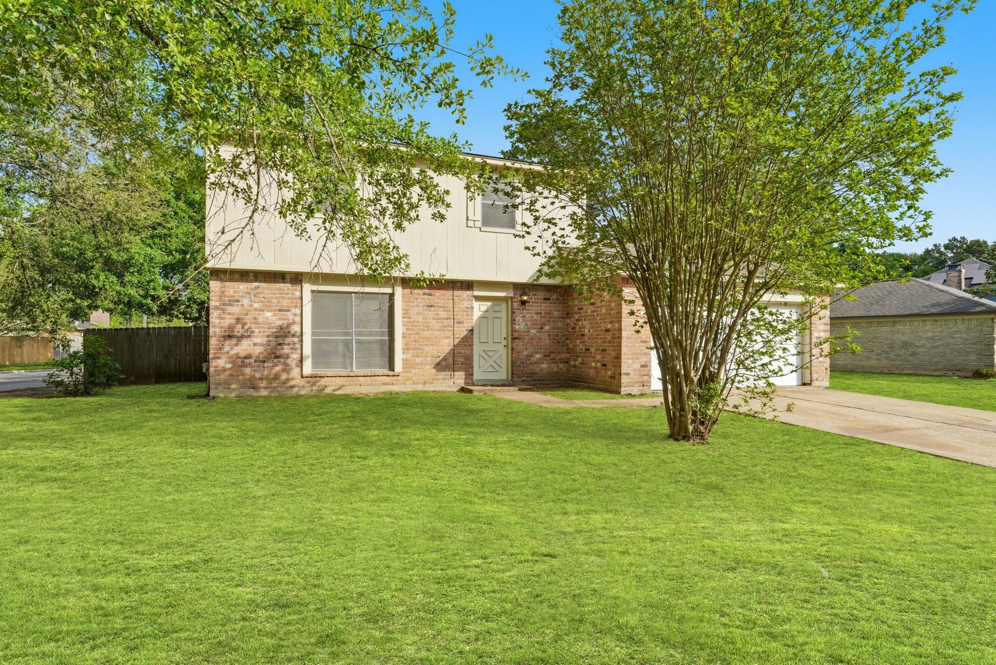 6914 Ten Curves Road Spring, TX 77379 - Photo 2 of 26 Spacious front yard surrounded in mature trees.