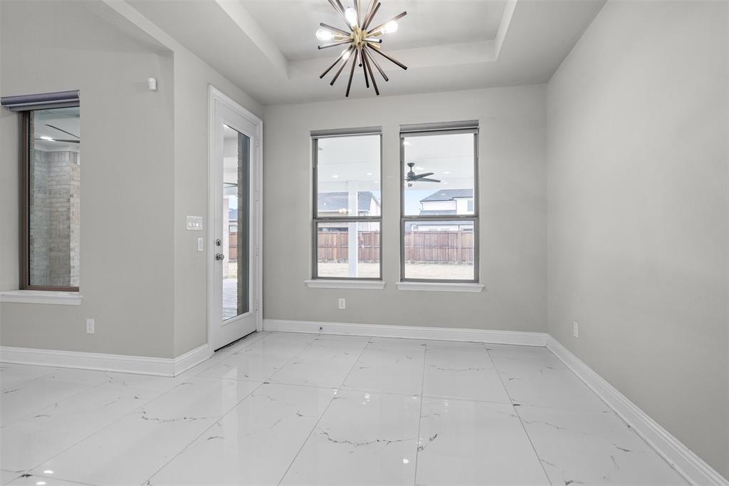 4505 Fall Mdw Drive Prosper, TX 75078 - Photo 11 of 34 an empty room with chandelier fan and windows