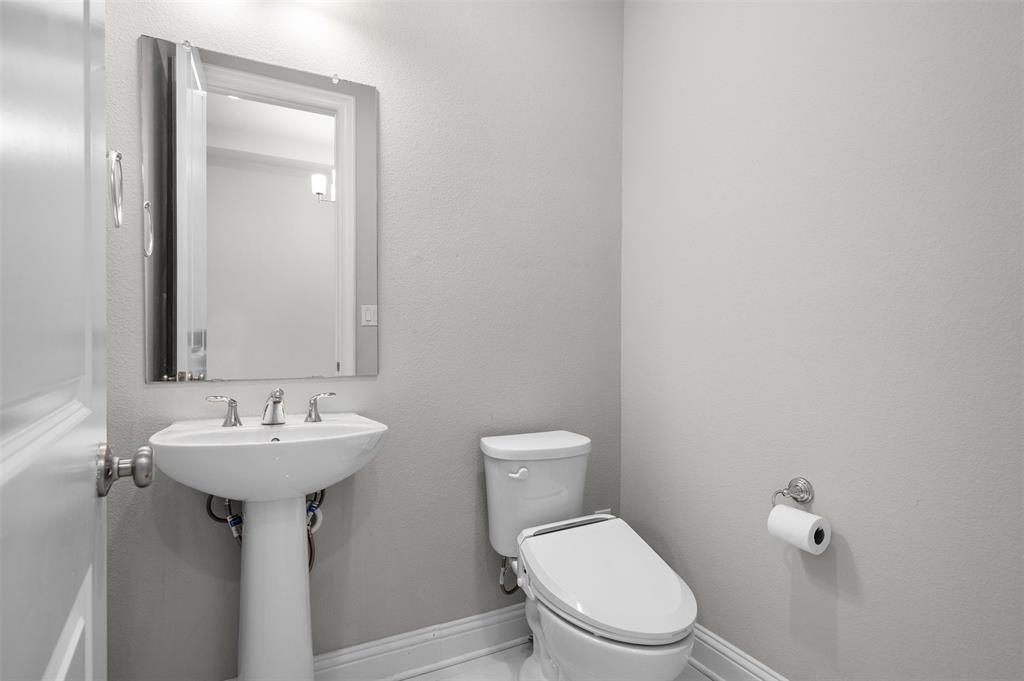 4505 Fall Mdw Drive Prosper, TX 75078 - Photo 13 of 34 a bathroom with a sink a mirror and a toilet